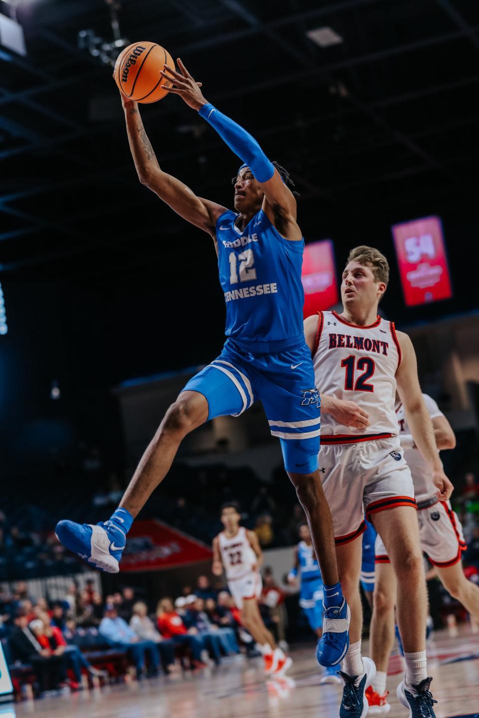 Middle Tennessee State's Teafale Lenard grabs a rebound over Belmont's Drew Friberg during Saturday's game at Curb Event Center.