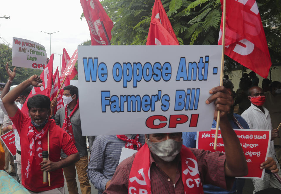 Members of All India Kisan Sangharsh Coordination Committee (AIKSCC) and activists of left parties and trade unions participate in a nationwide protest in Hyderabad, India, Friday, Sept. 25, 2020. Hundreds of Indian farmers took to the streets on Friday protesting new laws that the government says will boost growth in the farming sector through private investments, but they fear these are likely to be exploited by private players for buying their crops cheaply. (AP Photo/Mahesh Kumar A.)