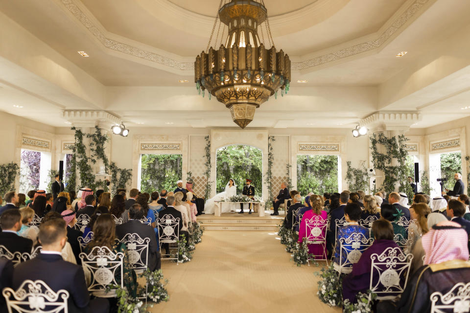 Jordan's Crown Prince Hussein and Rajwa Alseif sit during the wedding ceremony in Amman, Jordan, Thursday, June 1, 2023. (Royal Hashemite Court via AP)