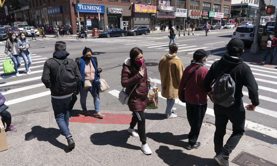 People walk on the street, Monday, April 26, 2021 in New York. The once-a-decade head count of the United States shows where the population grew during the past 10 years and where it shrank. New York will lose one seat in Congress as a result of national population shifts, according to census data released Monday. (AP Photo/Mark Lennihan)