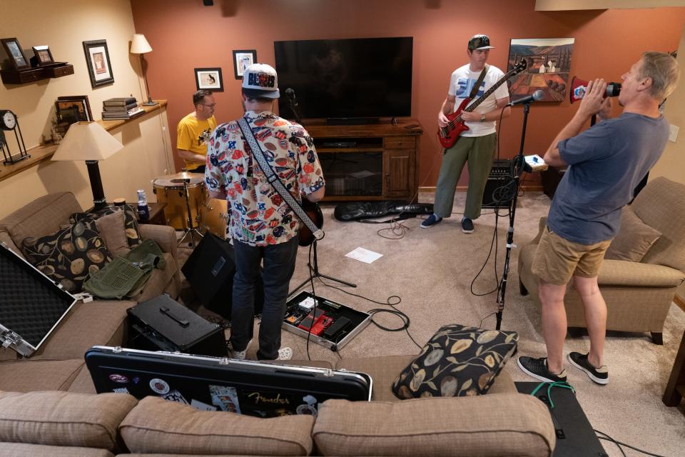 The sounds of 2000s-era alternative rock fill Randy Krome's basement as Untamed Mustangz practices for an upcoming gig Tuesday. The band consists of, from left, Sean Riley on drums, Ryan Bach on guitar, Zach Dinges on bass and Krome on vocal, came together while the four were all teachers at Seaman High School.