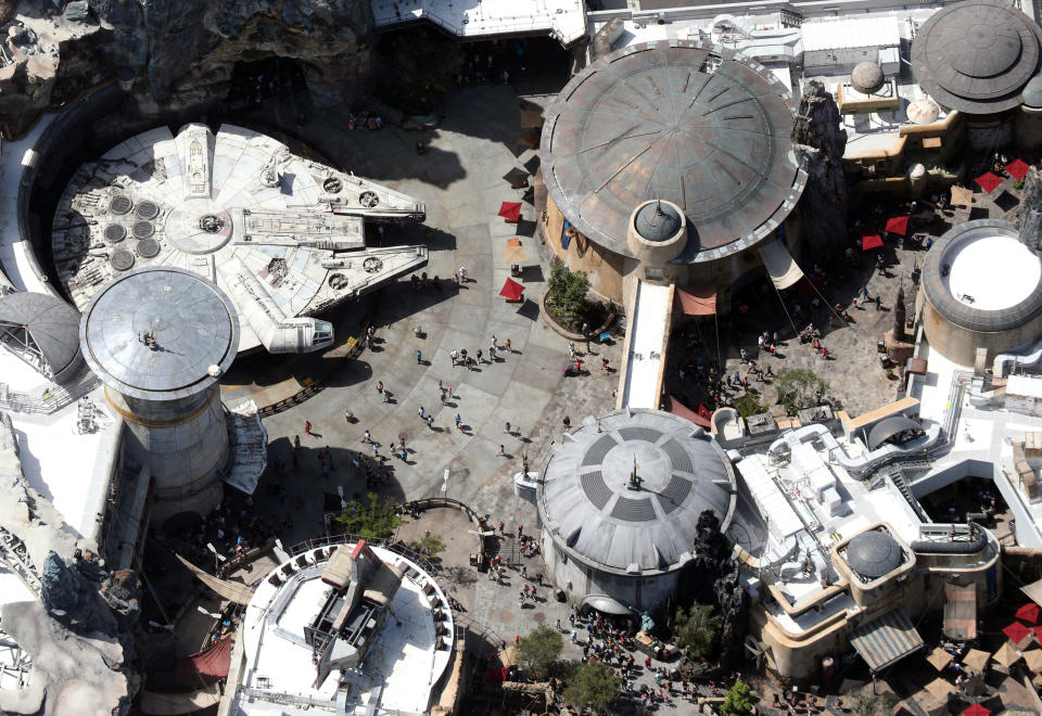 Crowds walk near the Millennium Flacon spaceship inside Star Wars: Galaxy's Edge at Disney's Hollywood Studios on the final day before closing in an effort to combat the spread of coronavirus disease (COVID-19), in an aerial view in Orlando, Florida, U.S. March 15, 2020. Picture taken March 15, 2020.  REUTERS/Gregg Newton