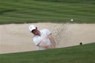 Rory McIlroy of Northern Ireland hits the ball out of the bunker on the third hole during the second round of the 2014 Omega Dubai Desert Classic in Dubai January 31, 2014. REUTERS/Ahmed Jadallah