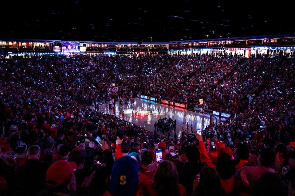 Fans light up the stands with cellphone flashlights during the first half an NCAA college basketball game between Colorado State and New Mexico in Albuquerque, New Mexico on Wednesday.