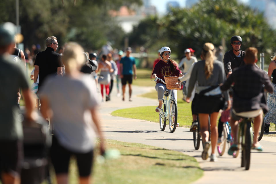 GOLD COAST, AUSTRALIA - MAY 02: People ride bikes along Miami foreshore on May 02, 2020 in Gold Coast, Australia. The Queensland government has eased COVID-19 lockdown measures in response to a decline in coronavirus cases across the state. From Saturday 2 May, Queenslanders are allowed to leave their homes for recreational activities, such as motorbiking or boating, picnics, visiting national parks or going shopping for non-essential items. Social distancing must still be observed and people must stay within 50km of their principle residence. (Photo by Chris Hyde/Getty Images)