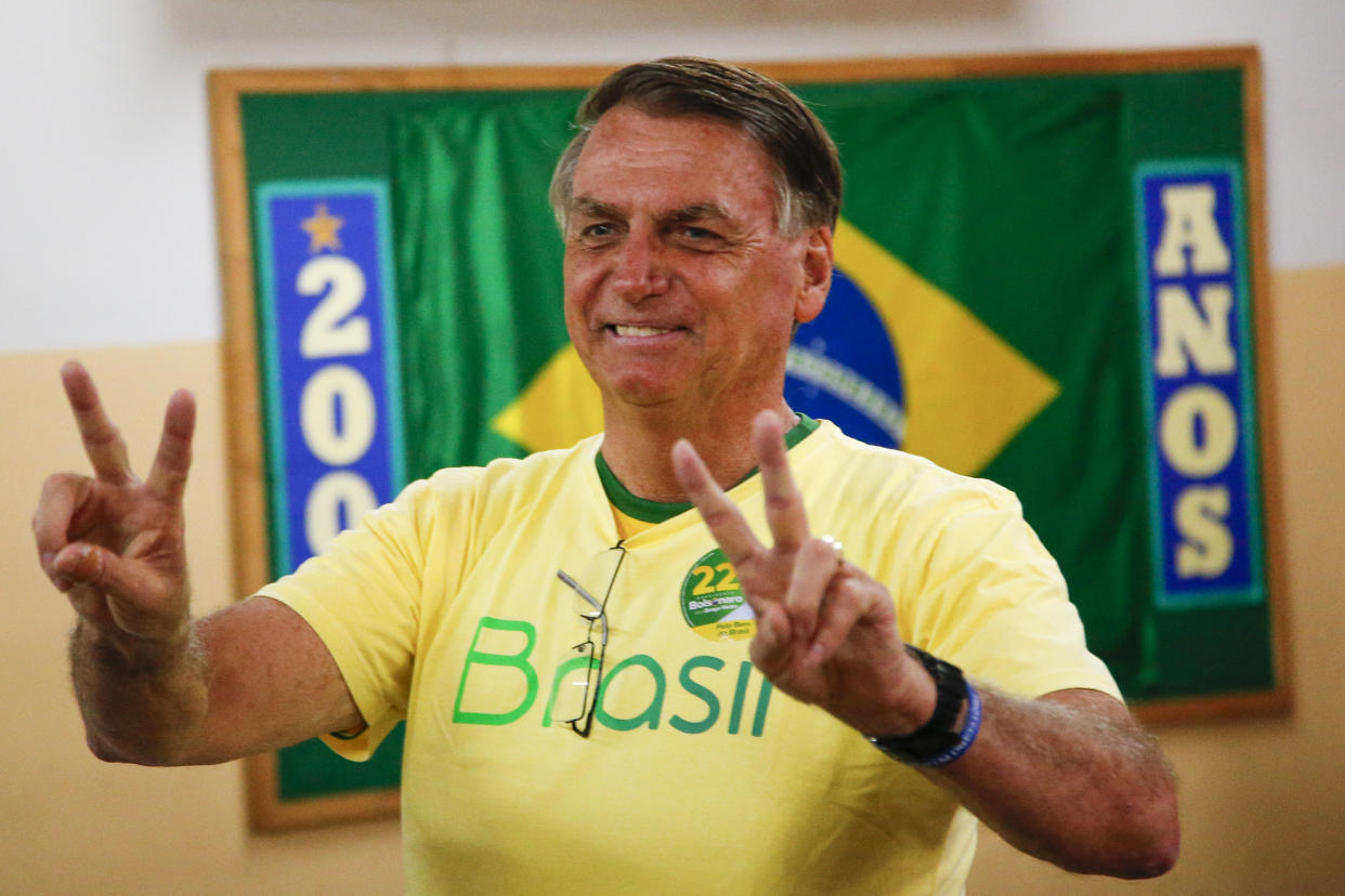 Brazilian President Jair Bolsonaro, who is running for another term, makes the victory sign after voting in a second round presidential election in Rio de Janeiro, Brazil, Sunday, Oct. 30, 2022. (AP Photo/Bruna Prado, Pool)