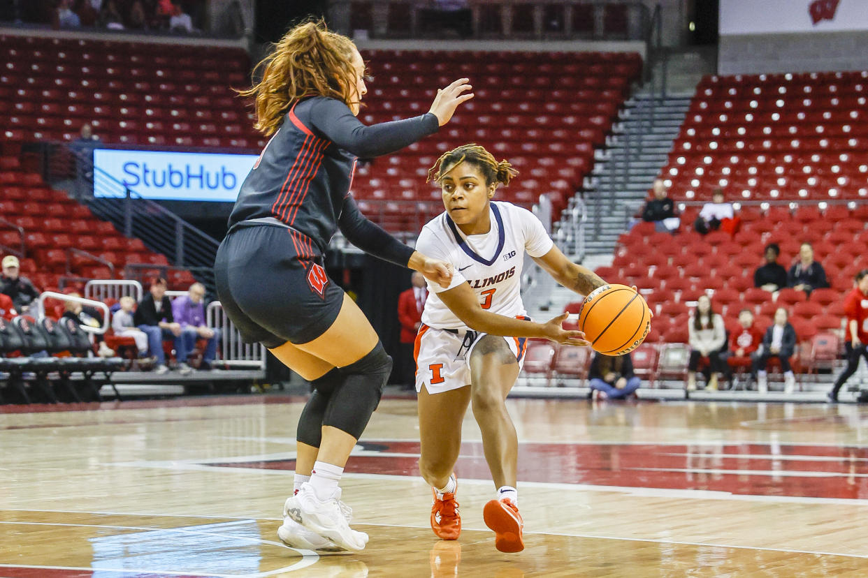 Illinois guard Makira Cook looks to pass the ball around Wisconsin guard Brooke Schramek during a women's college basketball game on Dec. 29, 2022. Illinois has had one of the biggest turnarounds this season. (Lawrence Iles/Icon Sportswire via Getty Images)