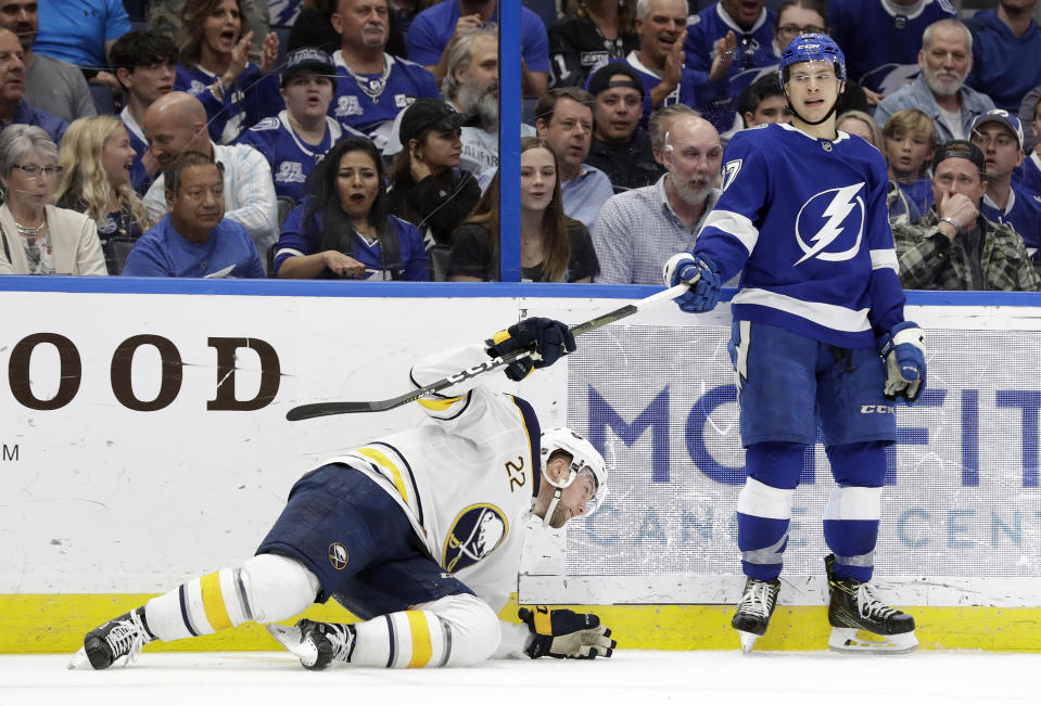 Buffalo Sabres center Johan Larsson (22), of Sweden, holds Tampa Bay Lightning center Yanni Gourde's stick after he was knocked down by Gourde during the second period of an NHL hockey game Thursday, Feb. 21, 2019, in Tampa, Fla. (AP Photo/Chris O'Meara)