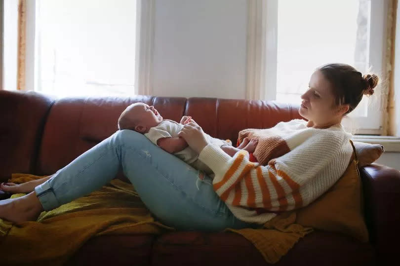 Tired mother with baby