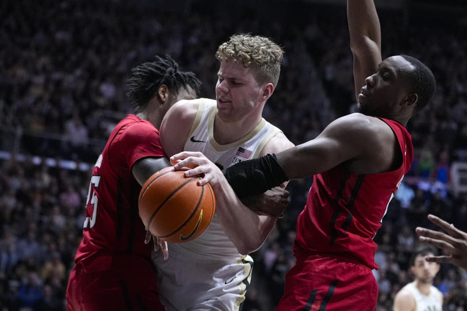Purdue forward Caleb Furst (1) is found by Rutgers guard Jeremiah Williams (25) and forward Aundre Hyatt, right, during the second half of an NCAA college basketball game in West Lafayette, Ind., Thursday, Feb. 22, 2024. (AP Photo/Michael Conroy)