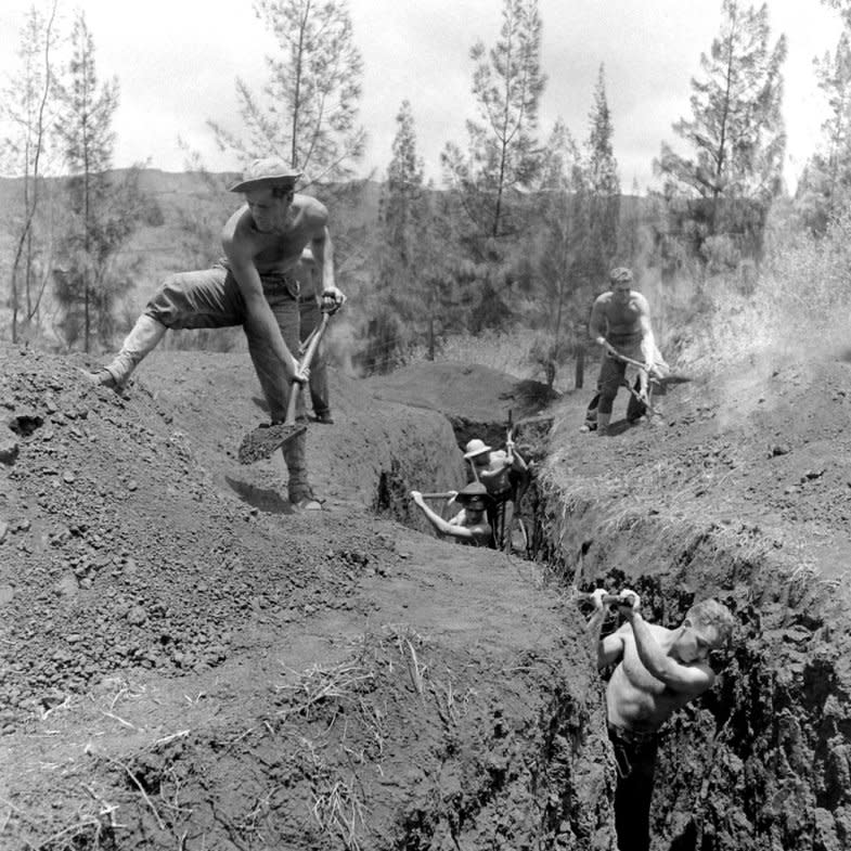 Not originally published in LIFE. Men dig a post-Pearl Harbor defensive trench in Hawaii, December 1941. (William C. Shrout—Time & Life Pictures/Getty Images) <br> <br> <a href="http://life.time.com/history/pearl-harbor-photos-from-the-pacific-and-the-home-front-1941-1942/#1" rel="nofollow noopener" target="_blank" data-ylk="slk:Click here to see the full collection at LIFE.com;elm:context_link;itc:0;sec:content-canvas" class="link ">Click here to see the full collection at LIFE.com</a>