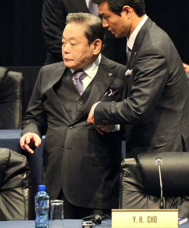 Samsung Group's Lee Kun-Hee is assisted into a chair at Pyeongchang's 2018 Winter Olympic bid presentation on July 6, 2011 in Durban