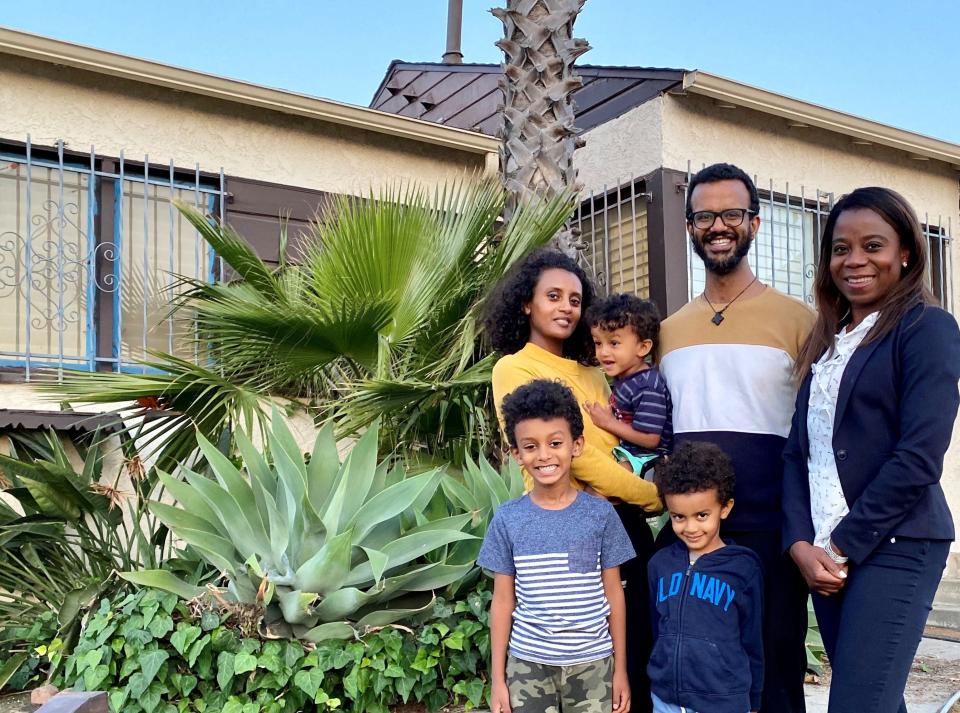 Yoni and Meaza Kebede with their children and their real estate agent Misty Afolabi (right).
