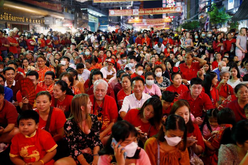 People wear masks as they celebrate Chinese Lunar New Year in Chinatown in Bangkok