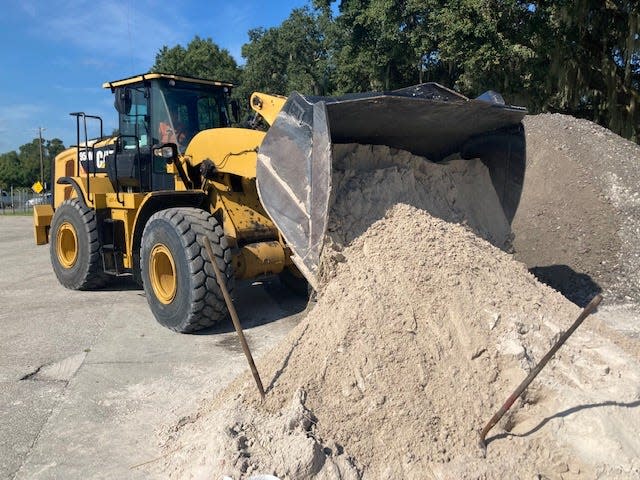 County crews bring more sand into the Mulberry distribution site on Monday morning as residents prepare for anywhere from three to eight inches of rain from Hurricane Ian.