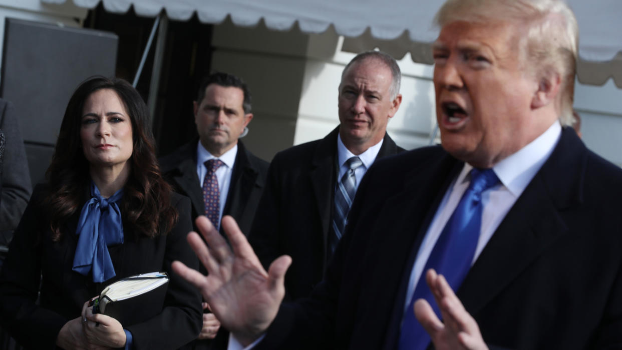 White House Press Secretary Stephanie Grisham (L) listens to U.S. President Donald Trump talk to reporters before he boards Marine One and departing the White House November 08, 2019 in Washington, DC. (Chip Somodevilla/Getty Images)