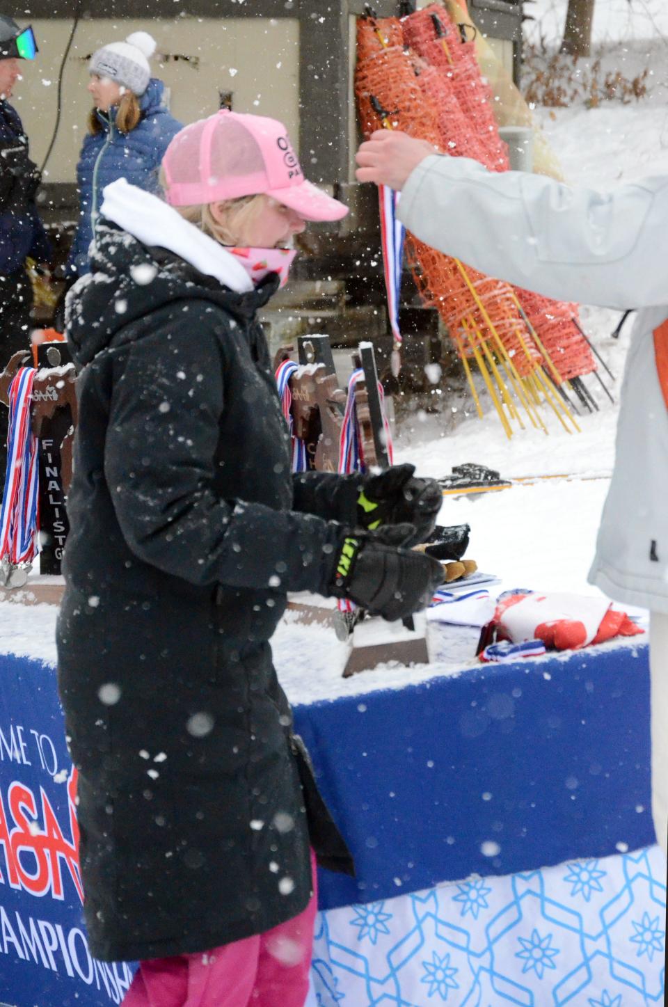 Kaija Lazda receives her medal at the D2 state finals at Boyne Mountain in Boyne Falls, Mich. on Monday, Feb. 27
