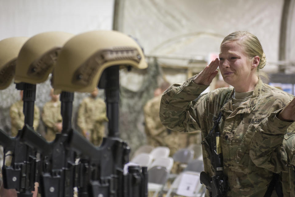 FILE - In this Dec. 23, 2015 file photo, a U.S. service member salutes her fallen comrades during a memorial ceremony for six Airmen killed in a suicide attack, at Bagram Air Field, Afghanistan. ter 20 years America is ending its “forever” war in Afghanistan. There’s conflicting views even among U. S. military minds as to whether the time is right. For others there is another lingering question: Was it worth it? (Tech. Sgt. Robert Cloys/U.S. Air Force via AP)