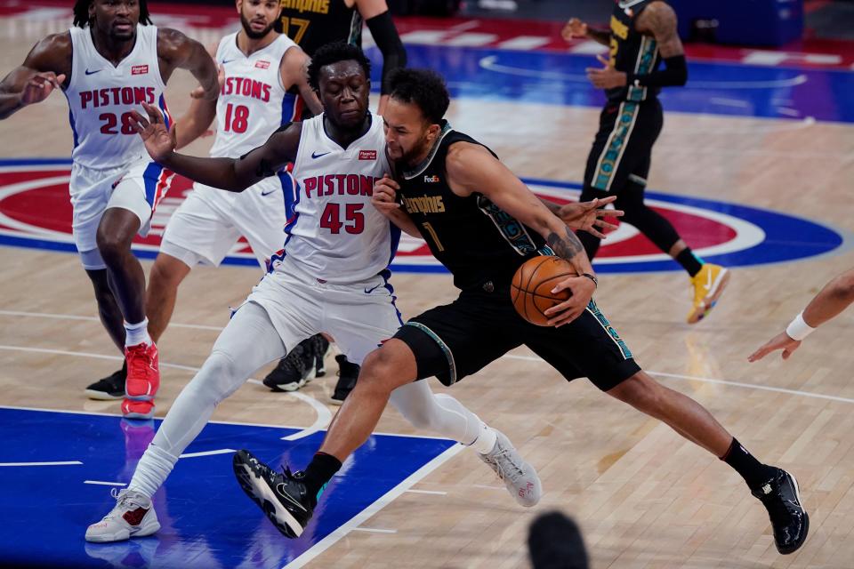 Memphis Grizzlies forward Kyle Anderson (1) runs into Detroit Pistons forward Sekou Doumbouya (45) during the second half at Little Caesars Arena in Detroit on Thursday, May 6, 2021.