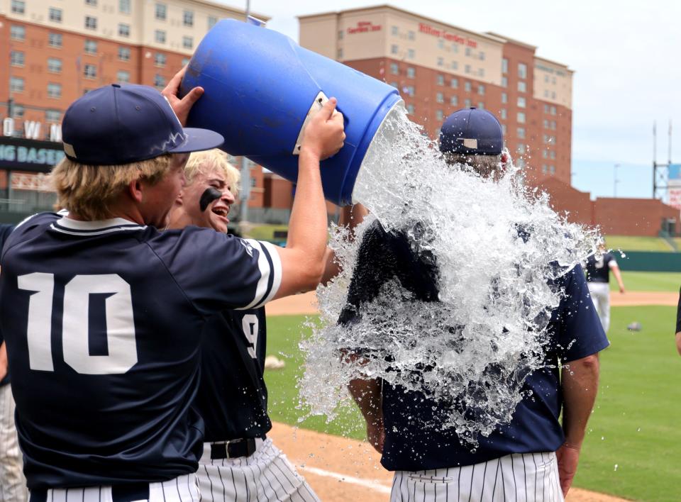 Marlow's Austin Harris, left, and Jackson Miller pour water on head coach John Morgan during the Class 4A baseball state championship between Marlow and Blanchard at Chickasaw Bricktown Ballpark in Oklahoma City, Saturday, May, 11, 2024.