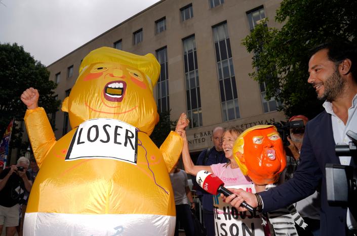 Protester dressed in a baby Trump costume.