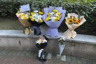 Floral tributes left outside Wuhan Central Hospital in memory of Li Wenliang, the whistleblower doctor who sounded the alarm and was reprimanded by local police for it in the early days of Wuhan's pandemic, prior to the anniversary of his death, in central China's Hubei province, Saturday, Feb. 6, 2021. Dr. Li Wenliang died in the early hours of Feb. 7 from the virus first detected in this Chinese city. A small stream of people marked the anniversary at the hospital. The 34-year-old became a beloved figure and a potent symbol in China after it was revealed that he was one the whistleblowers who authorities had punished early for “spreading rumors” about a SARS-like virus. (AP Photo/Ng Han Guan)