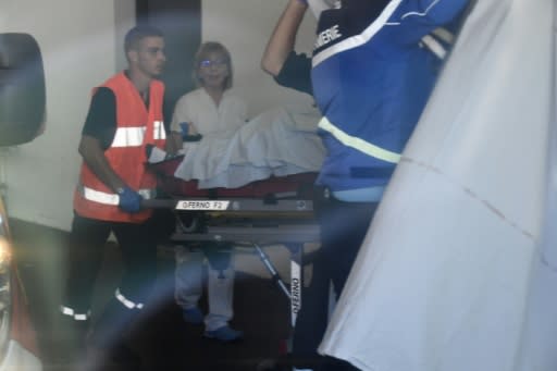 Rescue workers with Froome on a stretcher on his arrival at hospital