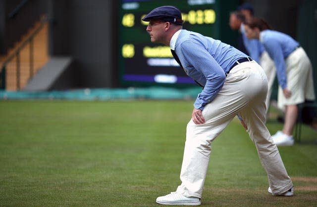 Line judges officiate on a court at Wimbledon 