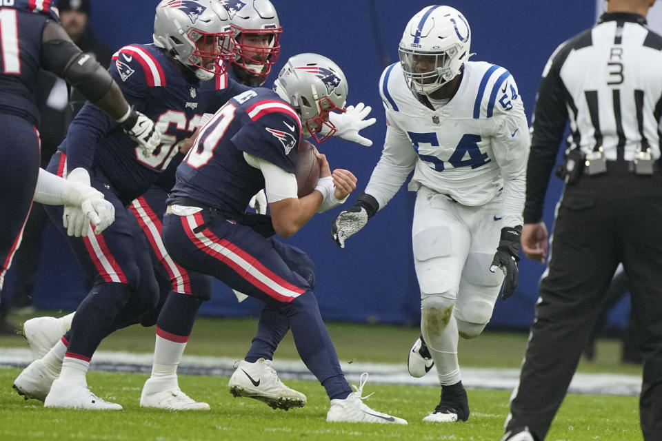 New England Patriots quarterback Mac Jones carries against Indianapolis Colts defensive end Dayo Odeyingbo (54) in the first half of an NFL football game in Frankfurt, Germany Sunday, Nov. 12, 2023. (AP Photo/Martin Meissner)