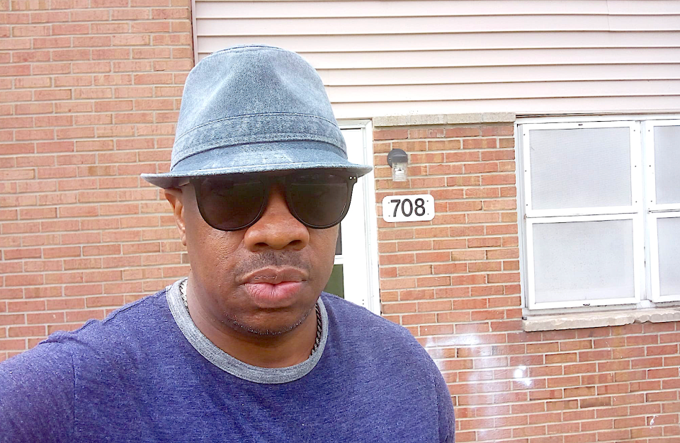 Rockford poet and community activist Christopher Sims stands in front of Unit 708, his childhood apartment at Fairgrounds Valley public housing complex, on Tuesday, April 16, 2024, on the city's near west side.