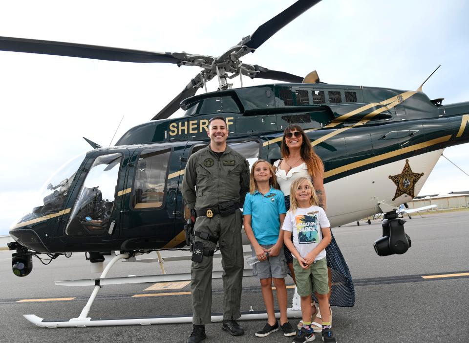 Sarasota County Sheriff's Office Aviation Unit, (a 2012 Bell 407GX helicopter) detective Hayden Gallof, poses with Rachael Cornwell and her sons Addison, 9, and Aston, 6.