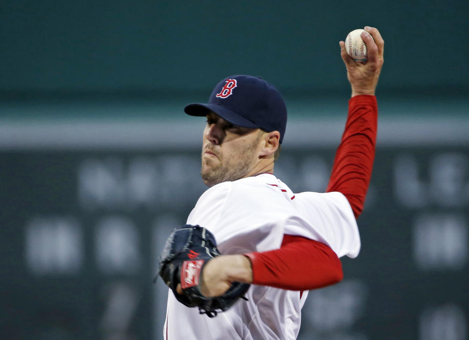 Boston Red Sox starting pitcher John Lackey delivers to the New York Yankees during the first inning of a baseball game at Fenway Park in Boston, Wednesday, April 23, 2014. (AP Photo/Elise Amendola)