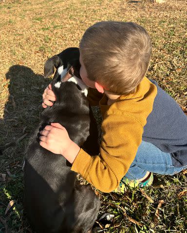 <p>Madison Nygard</p> Madison Nygard's son hugging Nova the dog