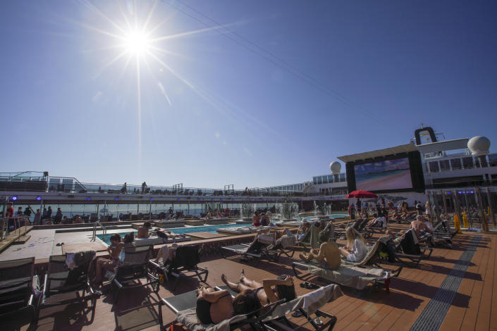 Passengers enjoy the sun by a swimming pool on board the MSC Grandiosa cruise ship in Civitavecchia, near Rome, Wednesday, March 31, 2021. MSC Grandiosa, the world's only cruise ship to be operating at the moment, left from Genoa on March 30 and stopped in Civitavecchia near Rome to pick up more passengers and then sail toward Naples, Cagliari, and Malta to be back in Genoa on April 6. For most of the winter, the MSC Grandiosa has been a lonely flag-bearer of the global cruise industry stalled by the pandemic, plying the Mediterranean Sea with seven-night cruises along Italy’s western coast, its major islands and a stop in Malta. (AP Photo/Andrew Medichini)