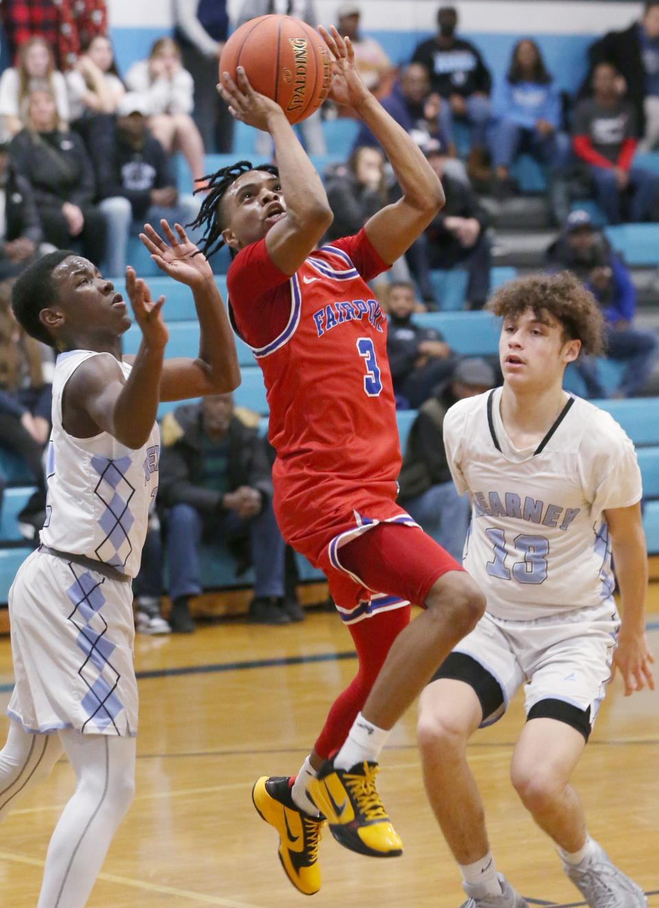 Fairport's LaShard Lowry Jr drives to the basket between Bishop Kearney's Russell Ellis and Maddox Volpe but can't convert the drive as the buzzer sounds ending the first half. Fairport won the close matchup 60-58.