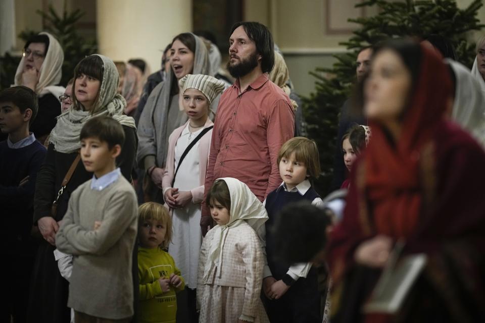 Russian Orthodox Church believers take part in an Orthodox Christmas service at the Church of the Holy Martyr Tatiana near the Kremlin Wall in Moscow, Russia, late Saturday, Jan. 6, 2024. (AP Photo/Alexander Zemlianichenko)