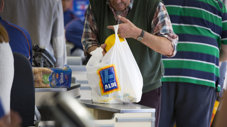 A man bags groceries 