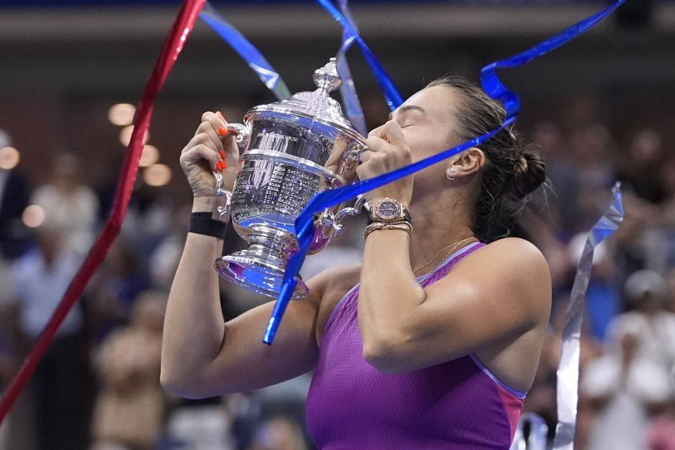 Aryna Sabalenka, of Belarus, kisses the trophy after winning the women's singles final of the U.S. Open tennis championships against Jessica Pegula, of the United States, , Saturday, Sept. 7, 2024, in New York. (AP Photo/Frank Franklin II)