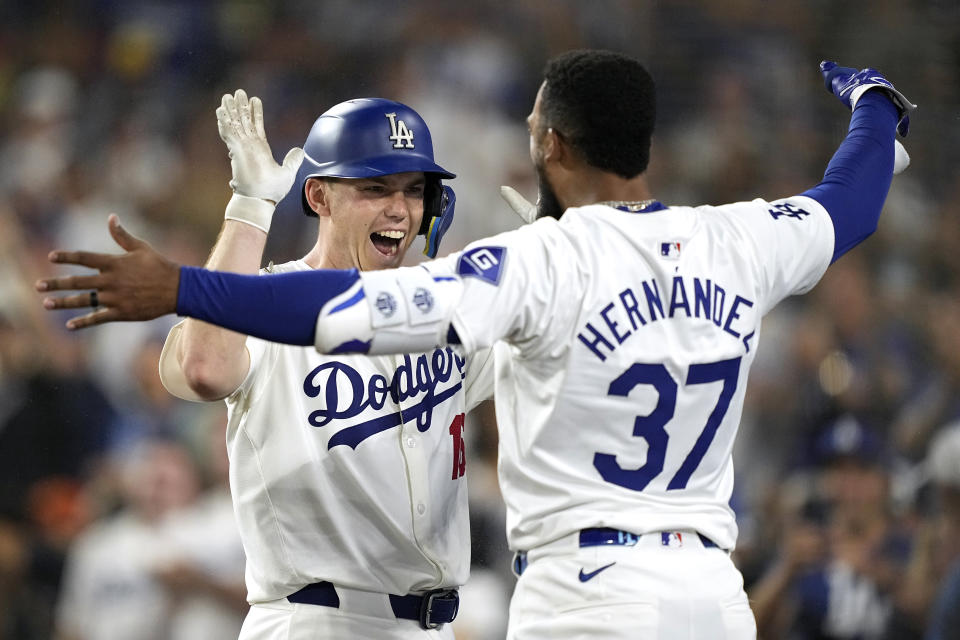 Los Angeles Dodgers' Will Smith, left, is congratulated by Teoscar Hernández after hitting a solo home run during the seventh inning of a baseball game against the Milwaukee Brewers Friday, July 5, 2024, in Los Angeles. (AP Photo/Mark J. Terrill)