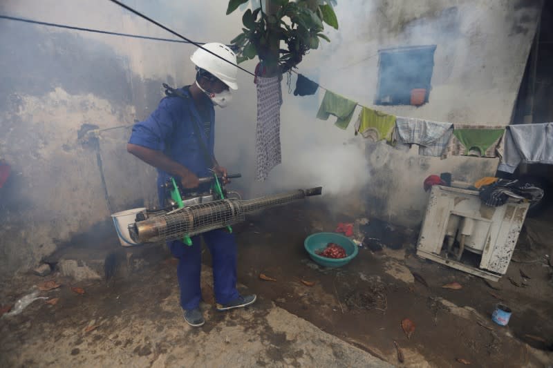 Health worker fumigates a residential area to curb the spread of dengue fever in Hodeidah