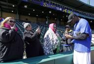 Retired NBA All-Star Tracy McGrady, right, signs autographs for season ticket holders after a workout at the Sugar Land Skeeters baseball stadium Wednesday, Feb. 12, 2014, in Sugar Land, Texas. McGrady hopes to tryout as a pitcher for the independent Atlantic League Skeeters. (AP Photo/Pat Sullivan)