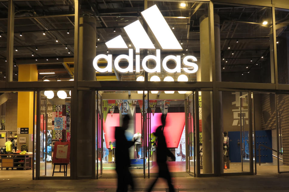 BEIJING, CHINA - APRIL 28: People walk past an Adidas store on April 28, 2021 in Beijing, China. (Photo by Lu Qijian/VCG via Getty Images)