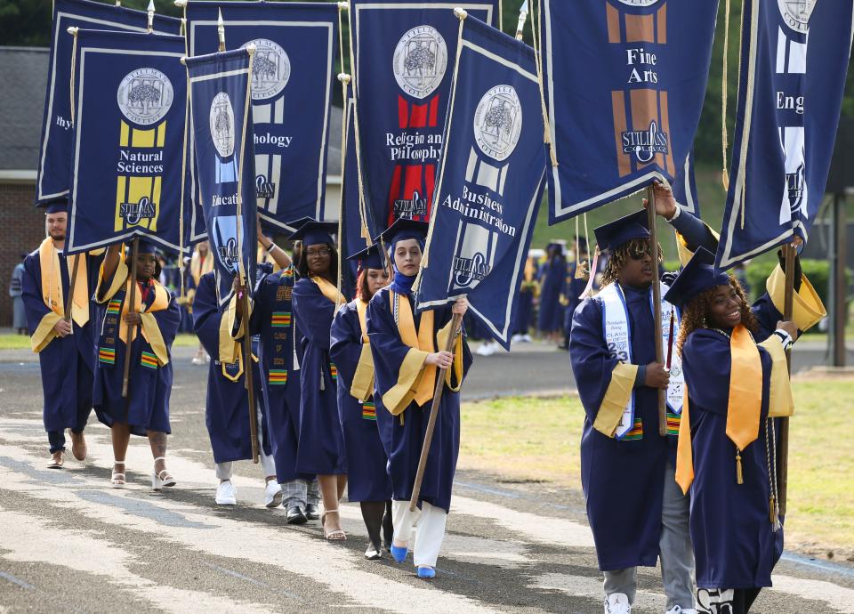 Stillman College graduates enter the football stadium for the commencement exercise May 6, 2023, at Stillman College.