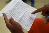 Immigration detainee Alexander Martinez points out his handwritten notations of allegations of abusive treatment, as he speaks during an interview with The Associated Press inside the Winn Correctional Center in Winnfield, La., Friday, July 30, 2021. (AP Photo/Gerald Herbert)