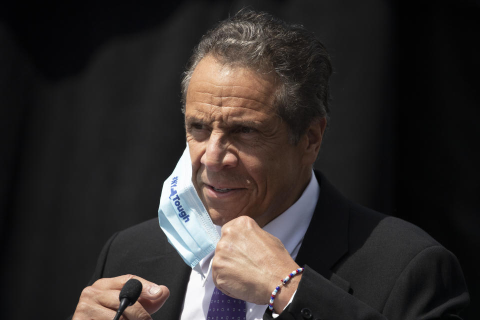 New York Gov. Andrew Cuomo removes a mask as he holds a news conference in a Monday, June 15, 2020 file photo, in Tarrytown, N.Y. New York Gov. Andrew Cuomo takes the reins of the group representing the nation’s governors, which has played a pivotal role in communicating with the Trump administration about state needs during the coronavirus pandemic. As head of the bipartisan National Governors Association, Cuomo will have to walk a fine line between his naturally combative style with the White House and a deferential approach favored by Republicans. (AP Photo/Mark Lennihan, File)