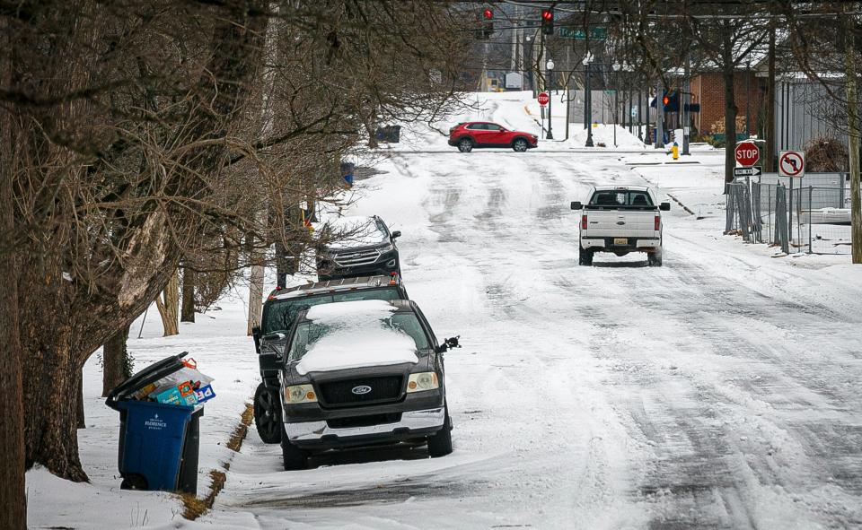 Motorists travel down a snow and ice covered road, Friday, Jan. 19, 2024 in downtown Florence, Ala.  (Dan Busey/The TimesDaily via AP) (AP)