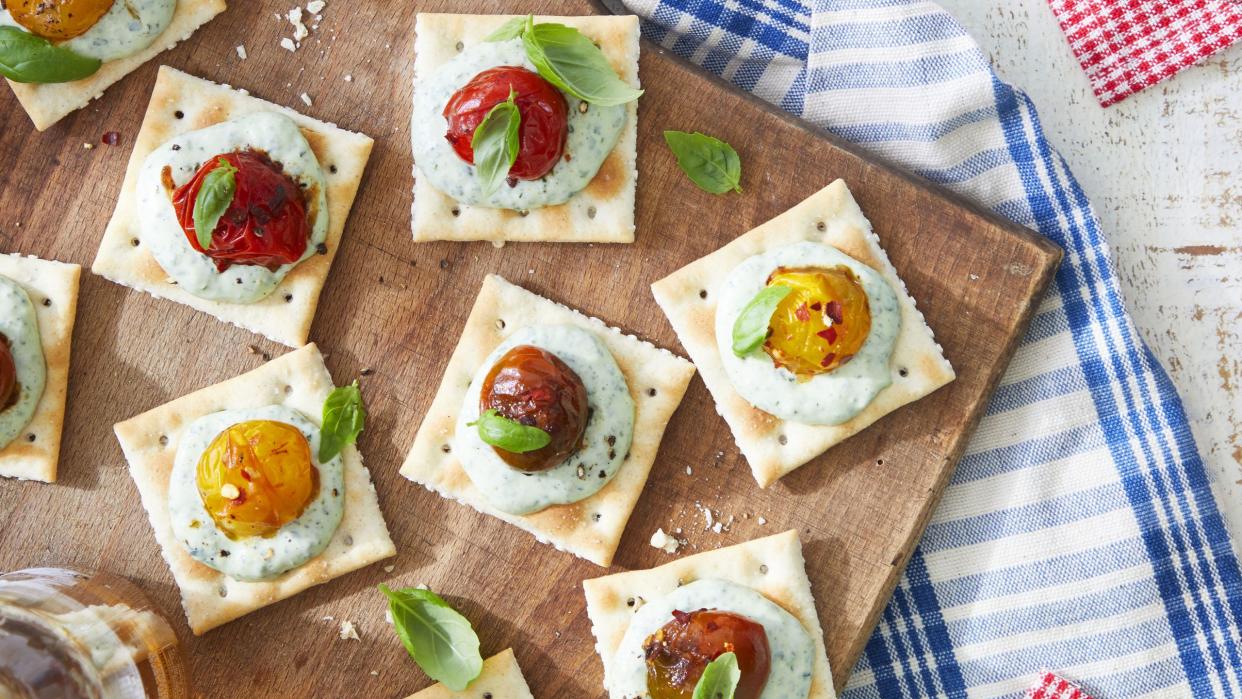 saltines with basil mayo and burst tomatoes