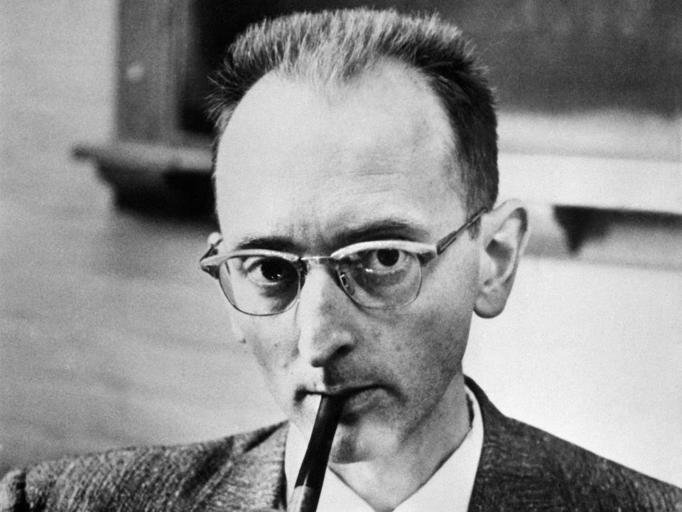 Nobel Prize winner Owen Chamberlain wears a suit and glasses and smokes a pipe circa 1950