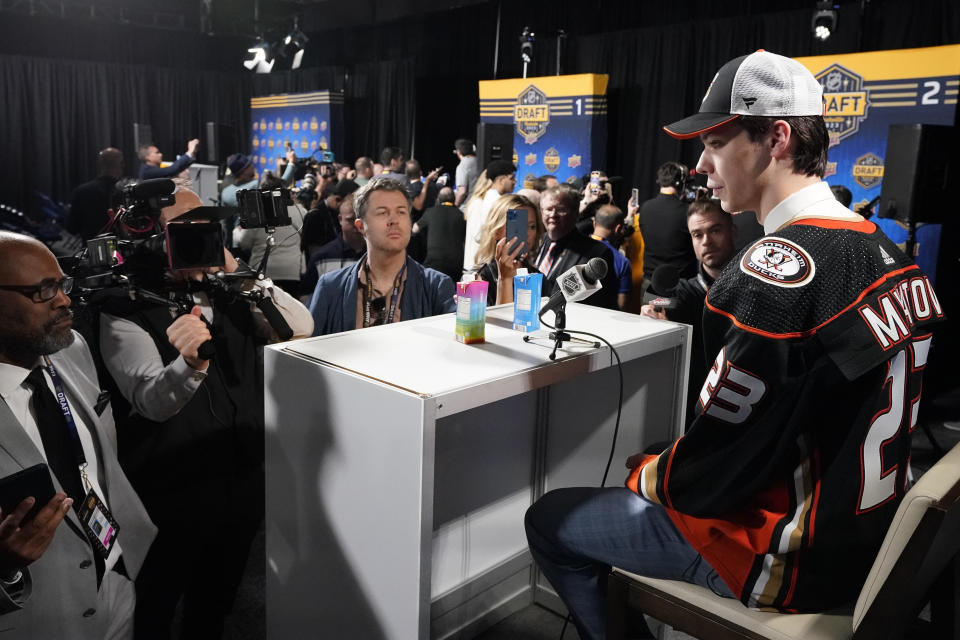 Nico Myatovic, right, speaks to the media after being picked by Anaheim Ducks during the second round of the NHL hockey draft Thursday, June 29, 2023, in Nashville, Tenn. (AP Photo/George Walker IV)