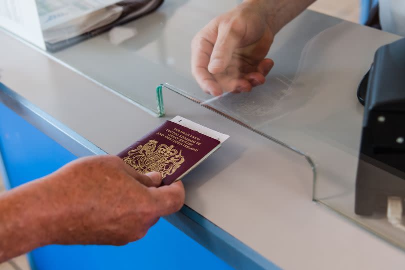 A passenger hands over their U.K. passport for inspection at a border control kiosk in the P&O Ferries Ltd. terminal at the Port of Zeebrugge in Zeebrugge, Belgium, on Tuesday, July 23, 2019.